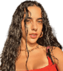 Person with long wet curly hair wearing a red top and gold hoop earrings is standing under a shaded structure with sunlight casting shadows. Description generated by AI