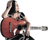 A person with shoulder-length hair wearing a striped top and patterned skirt is sitting while holding an acoustic guitar and looking to the side. Description generated by AI